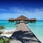 Ultimate tropical paradise beach destination with crystal-clear water and luxury resort for dream travel quests.