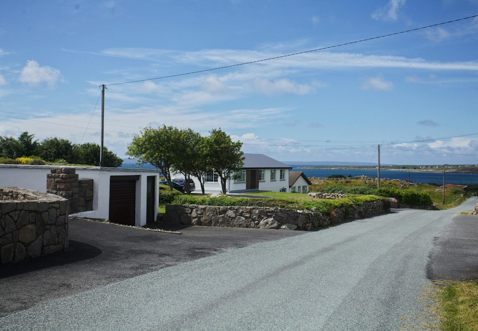 A scenic road winding along the dramatic, green cliffs of the Irish coast, representing the best things to see in Ireland on a road trip.