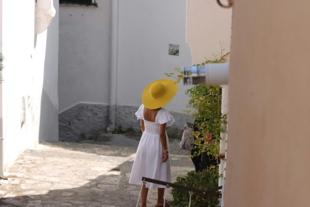 A traveler walks down a charming European cobblestone street, illustrating the perfect holiday destinations in Europe for a 2025 getaway.