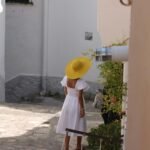 A traveler walks down a charming European cobblestone street, illustrating the perfect holiday destinations in Europe for a 2025 getaway.