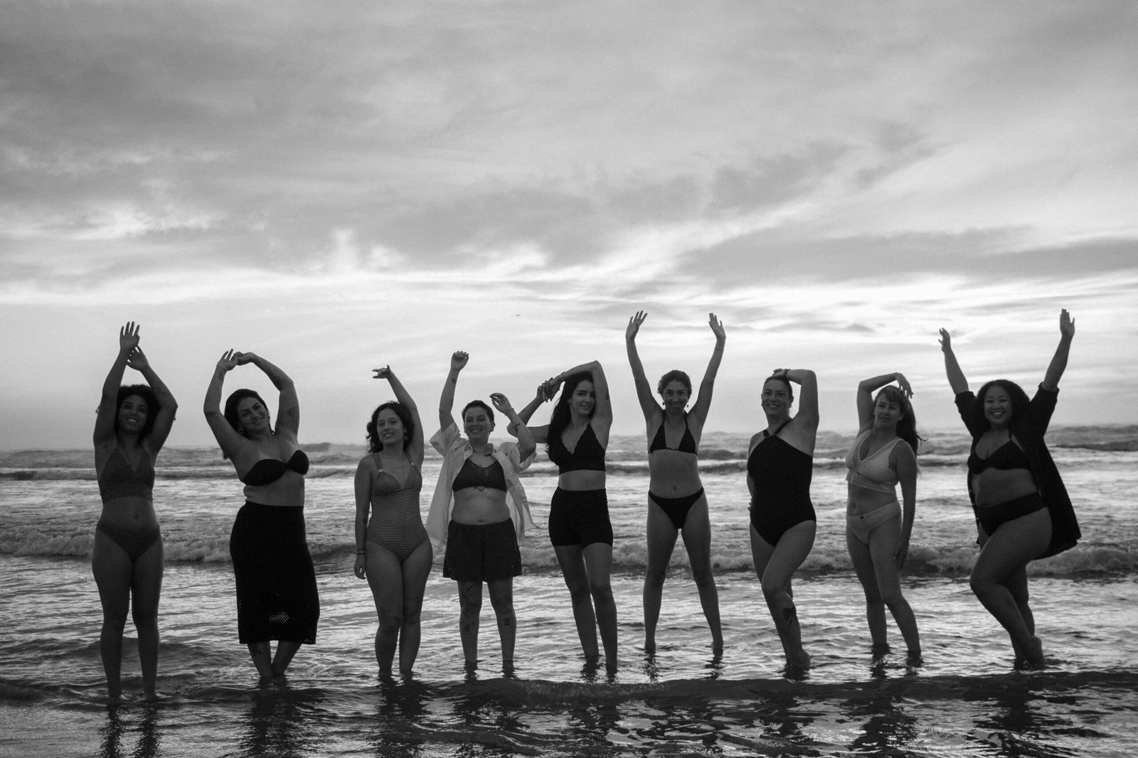 A confident solo traveler laughing with a small group of new friends during a solo travel tour in a beautiful scenic destination.