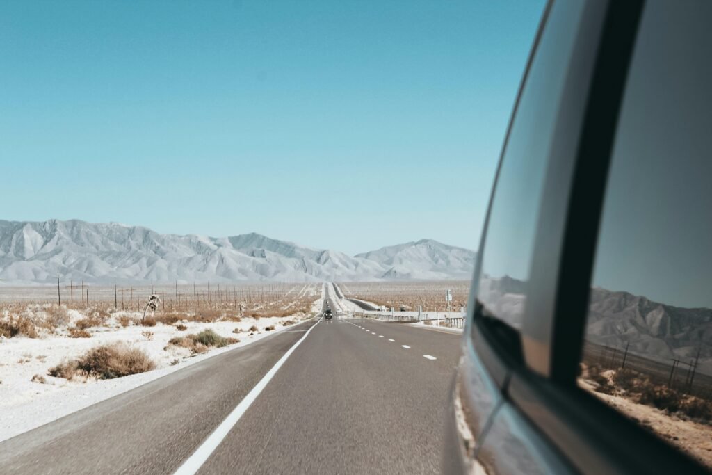 A scenic view of a winding road through a vast American landscape, illustrating one of the best places to travel in the US for an adventure vacation.