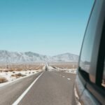 A scenic view of a winding road through a vast American landscape, illustrating one of the best places to travel in the US for an adventure vacation.