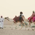 Stunning evening desert safari in Dubai at sunset, featuring golden sand dunes and a sense of adventure.