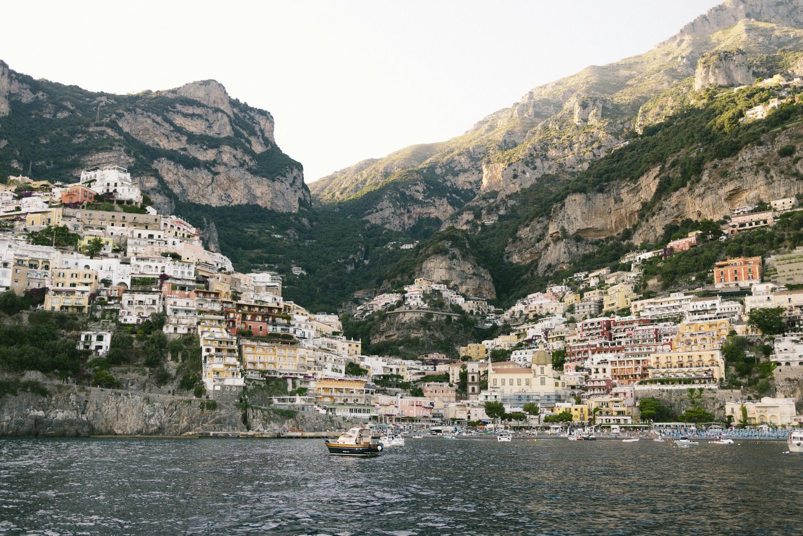 A traveler looks out over a colorful coastal town, representing one of the best European countries to visit in 2025.