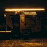 The Moapa Paiute Travel Plaza brightly illuminated at night in the Nevada desert, an inviting stop offering tax-free gas, snacks, and Native American cultural goods to travelers on I-15.