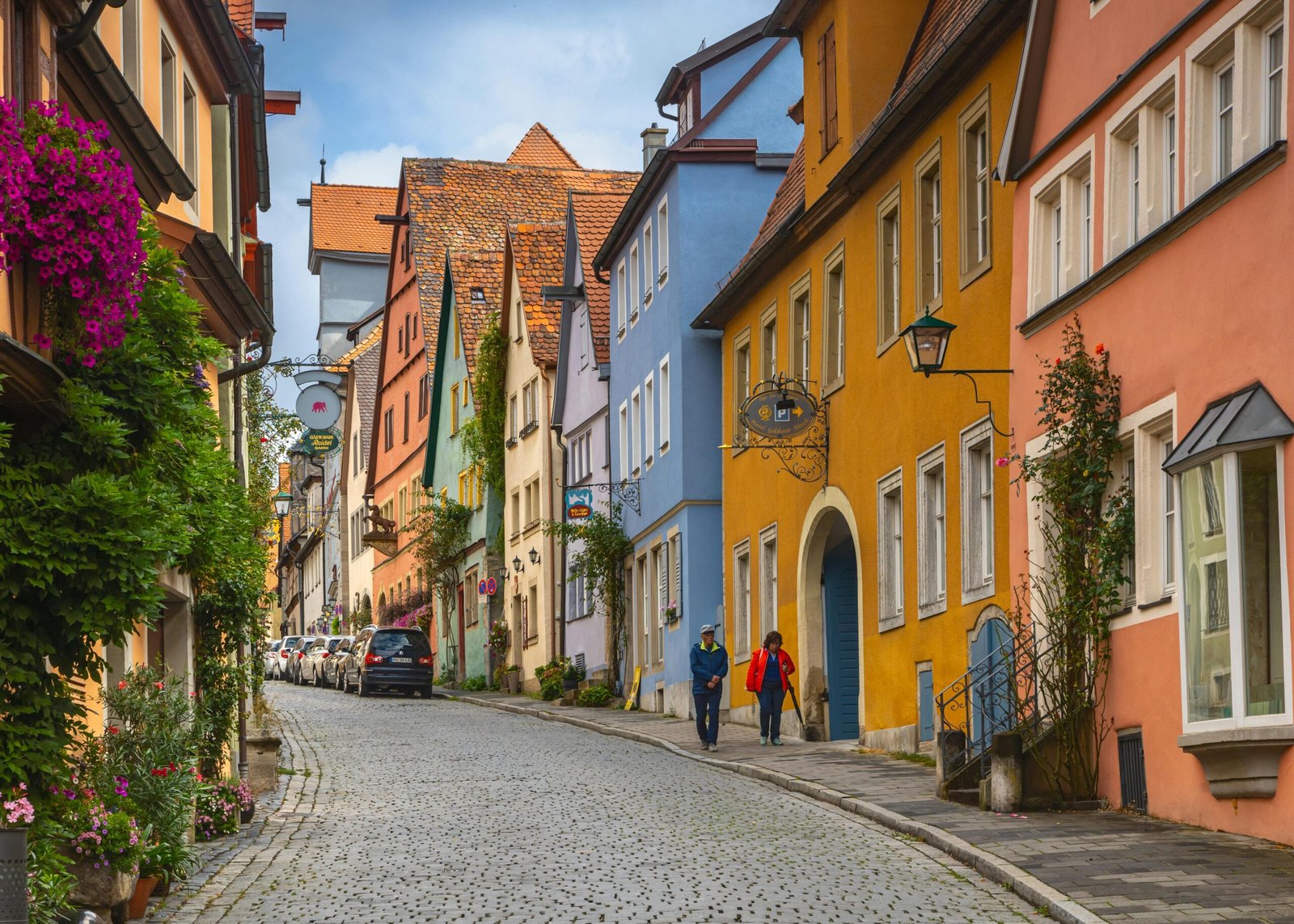 A picturesque cobblestone street in one of the top European cities to see, with colorful historic buildings lit by sunshine, inspiring a travel adventure.
