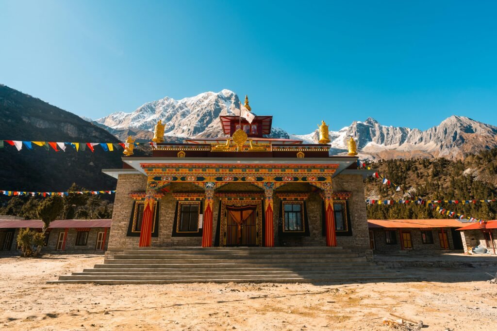 Colorful Tibetan prayer flags fluttering against a backdrop of the majestic Himalayan mountains, symbolizing travel and cultural exploration in the countries bordering India.