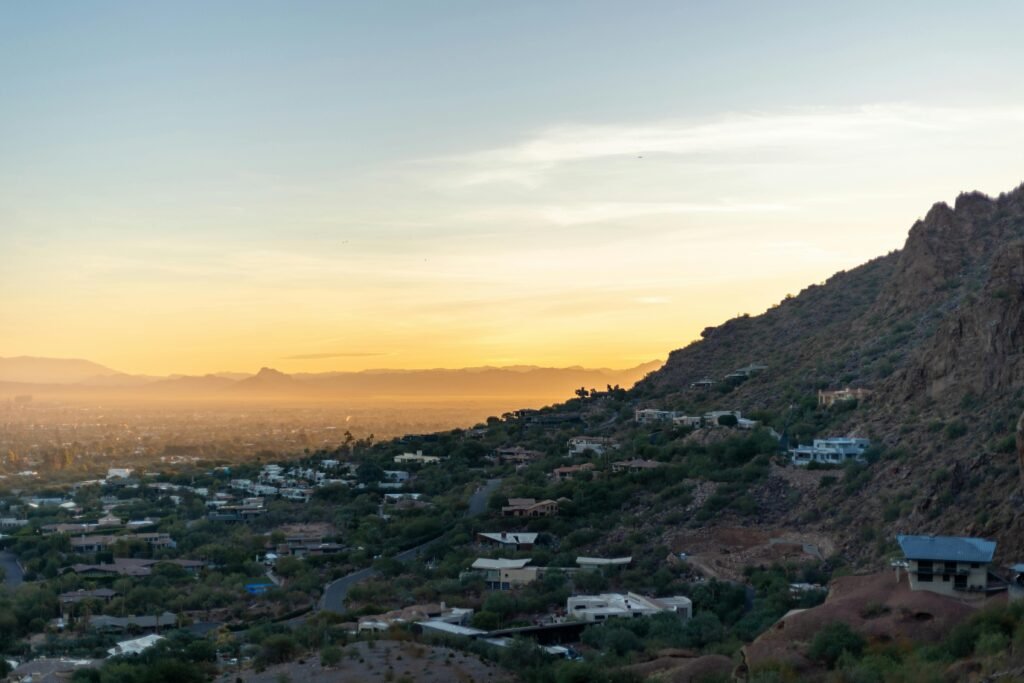 Panoramic view of a beautiful US city skyline from a mountain overlook at sunrise, showcasing one of the most scenic cities in the US.