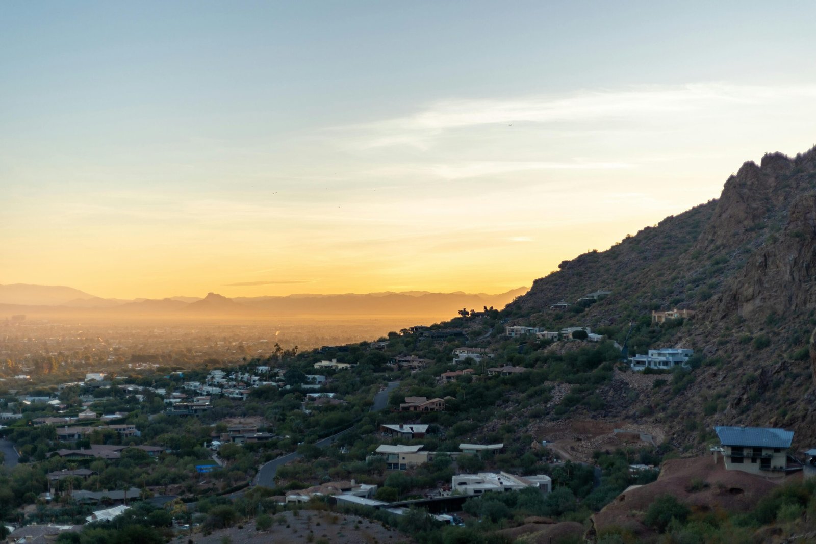 Panoramic view of a beautiful US city skyline from a mountain overlook at sunrise, showcasing one of the most scenic cities in the US.