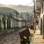 Charming cobblestone street in one of the world's prettiest cities at sunrise, showcasing beautiful architecture and a serene travel destination.