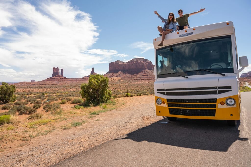 A car on an open road trip through a vast American landscape, illustrating the diverse and incredible places to visit in the USA.