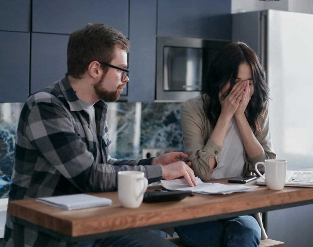 A person reviews paperwork for a Tripp Lite insurance claim at a desk with a damaged computer and surge protector, illustrating the claim process.