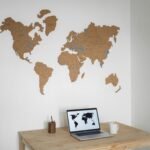 Professional travel agent using digital itinerary builder software on a laptop for efficient trip planning and enhanced client satisfaction.