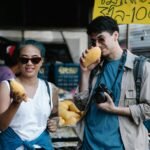 Budget traveler enjoying an authentic local market experience, illustrating affordable travel to the world's cheapest countries and cultural immersion.