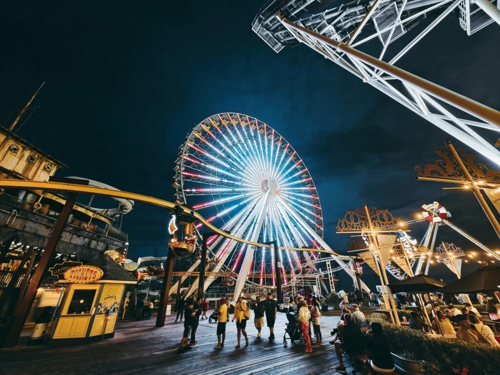 Vibrant scene of Wildwood Boardwalk at sunset, featuring iconic Morey's Piers amusement rides brightly lit, symbolizing peak summer vacation and crucial Wildwood Boardwalk hours.