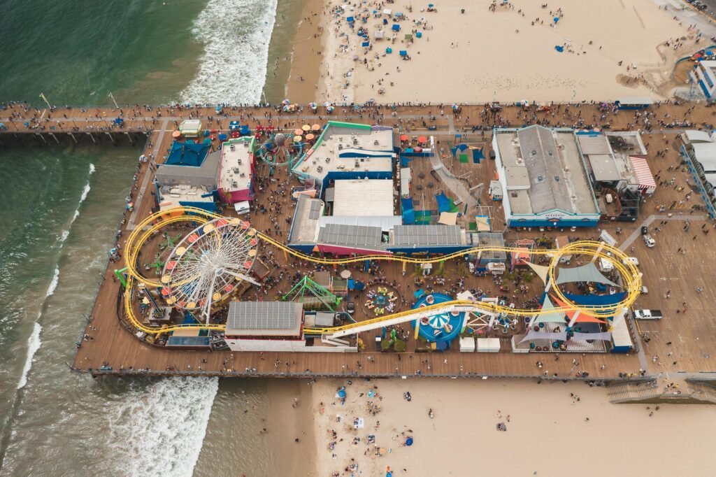 Aerial view of the sunny Wildwood, NJ beach and boardwalk, highlighting the best places to stay for a 2025 vacation.