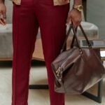 A stylish men's travel cosmetic bag (dopp kit) open, neatly organized with grooming essentials for efficient and refined travel.