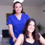 Confident traveling medical assistant smiling, ready for new assignments, highlighting the benefits of a dynamic healthcare career.