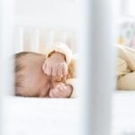Baby sleeping peacefully in a portable travel crib, best for family travel and vacations, offering safe and comfortable sleep for infants and toddlers on the go.